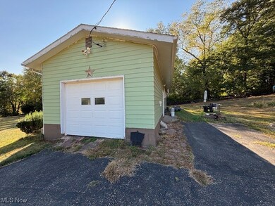 Detached garage with asphalt driveway