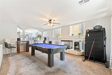 Playroom featuring carpet flooring, decorative columns, pool table, and a ceiling fan