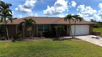 Ranch-style house with stucco siding, driveway, a
