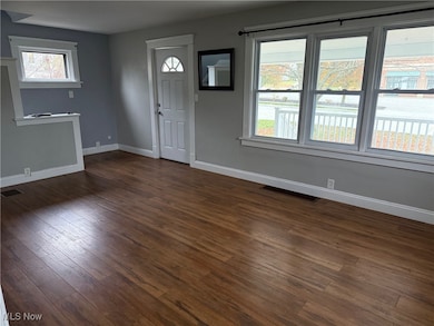 Entryway with baseboards and dark wood finished floors