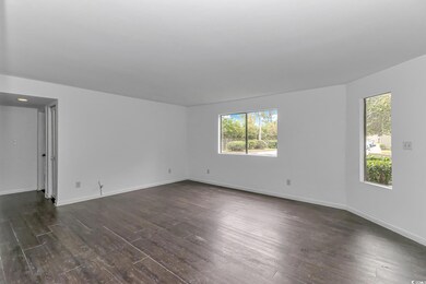 Empty room featuring dark hardwood / wood-style fl