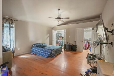 Bedroom with vaulted ceiling, ceiling fan, and har