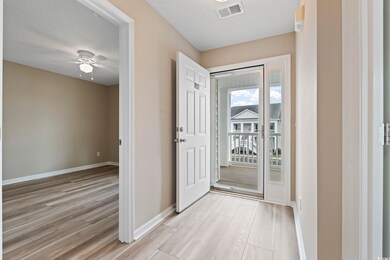 Entryway featuring light wood-type flooring, a ceiling fan, and baseboards