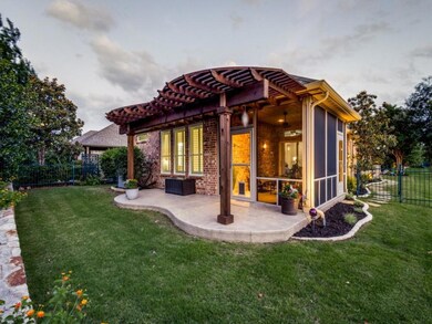 Back house at dusk featuring a patio, a pergola, a