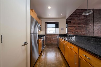 Kitchen with dark stone counters, appliances with 