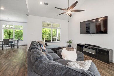 Living room featuring visible vents, wood finishe