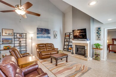 Vaulted ceiling in living room with fireplace anch