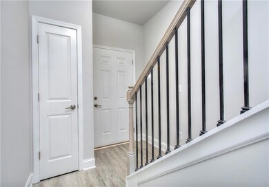 Stairs with wood finished floors and baseboards