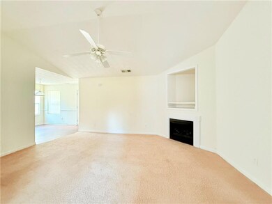 Unfurnished living room featuring a fireplace, vis