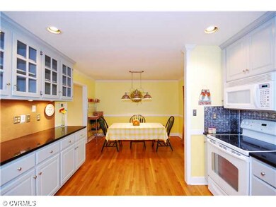 Kitchen - Large kitchen has wood floors, recessed 