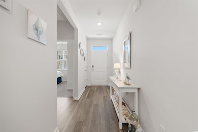 Foyer entrance with baseboards and wood finished floors