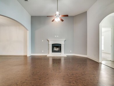 Unfurnished living room featuring dark hardwood / wood-style floors and ceiling fan
