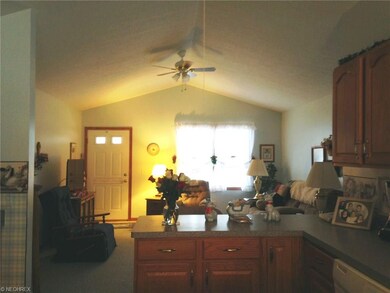 The high ceiling in the living room and kitchen ma