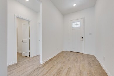 Entrance foyer with light hardwood / wood-style fl