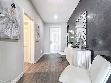 Entryway featuring baseboards and wood finished fl