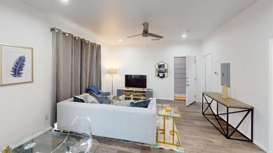 Living room with wood-type flooring, electric pane
