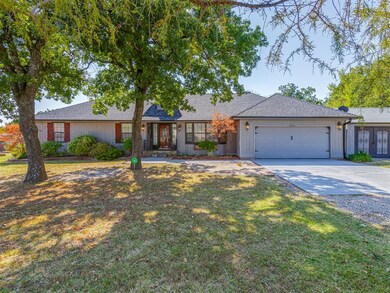 Ranch-style home featuring a garage and a front lawn