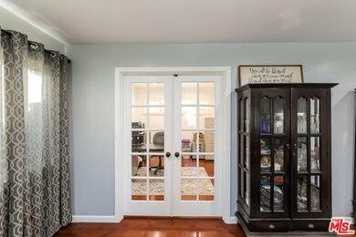 French doors open to an office or playroom