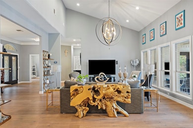 Living area featuring high vaulted ceiling, a cha