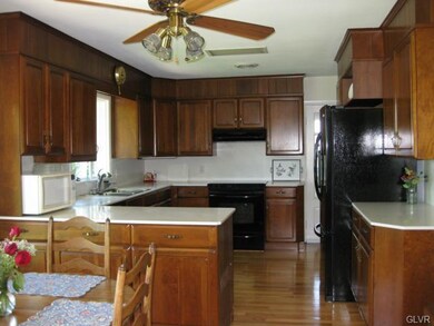Kitchen: Custom Cherry Cabinets with Corian Counte