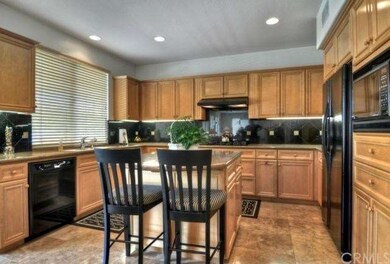 Beautiful gourmet kitchen with maple cabinets, gra