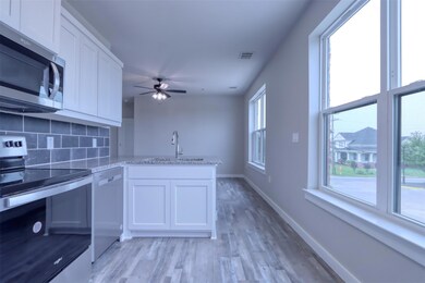 Kitchen with stainless steel appliances, ceiling f