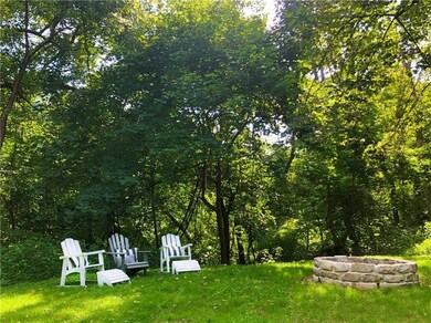 Sited on a beautiful multi-parcel property backing to woods and a babbling creek, there is plenty of yard space for all of your favorite outdoor pursuits.