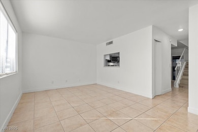 Spare room with light tile patterned floors, stairway, and recessed lighting