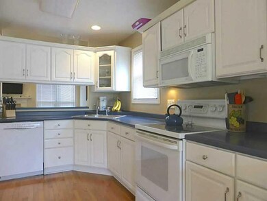 Kitchen. Hardwood Floors and a Pass-Through to the