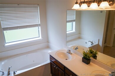 Relaxing jacuzzi tub in Master bath. More great li