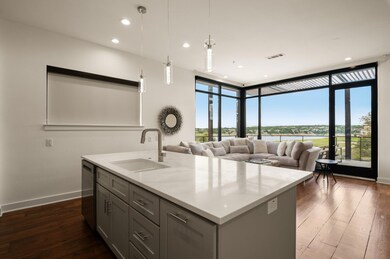 Kitchen with a sink, expansive windows, baseboard