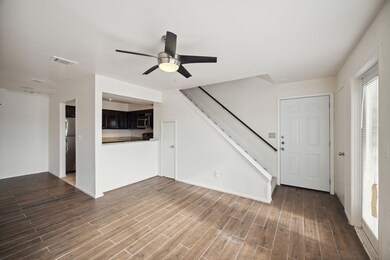 Unfurnished living room featuring ceiling fan and 