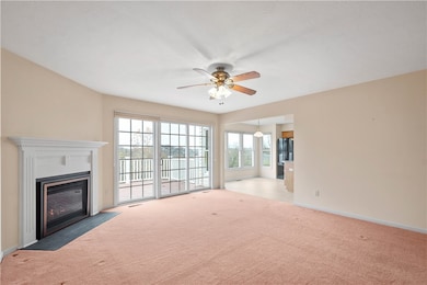 SPACIOUS LIVING ROOM WITH AN UPDATED GAS FIREPLACE . SLIDING DOOR ALLOWS AN ABUNDANCE OF NATURAL LIGHT AND  LEADS OUT TO LARGE DECK.
