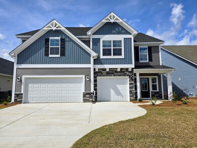 Craftsman inspired home with driveway, stone siding, board and batten siding, a garage, and central AC