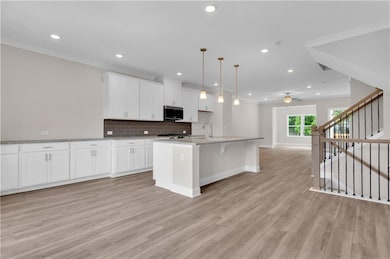 Kitchen featuring stainless steel microwave, open 