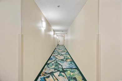 Hallway with a textured ceiling