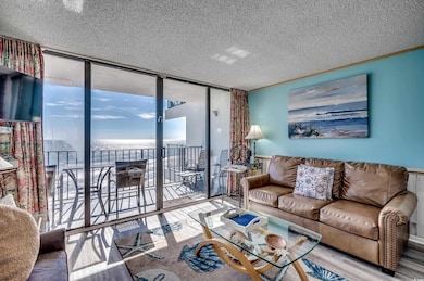 Living room featuring a water view, wood-type floo