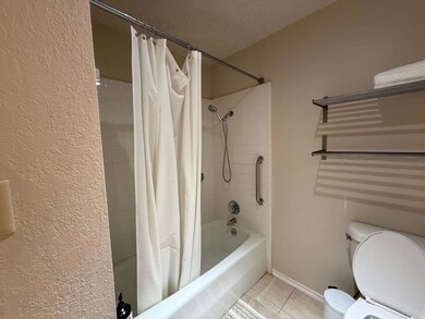 Bathroom with shower / tub combo with curtain, ti