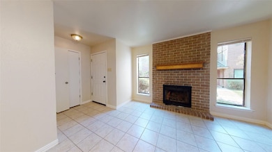 Unfurnished living room with a brick fireplace and