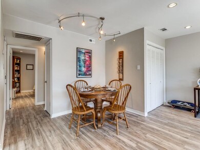 Dining space featuring rail lighting and light woo