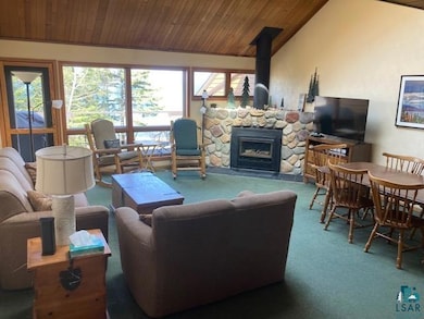 Living room featuring carpet, wooden ceiling, and 