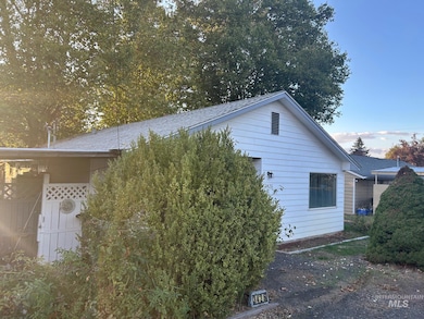 View of side of property with a shingled roof