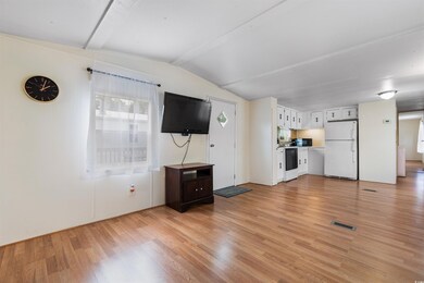 Unfurnished living room featuring lofted ceiling a