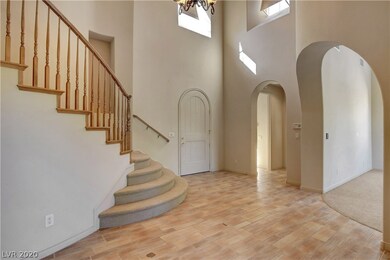 Dramatic entry opens to curved staircase