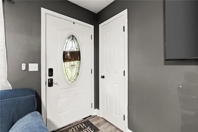 Entrance foyer featuring light wood-style floors and baseboards