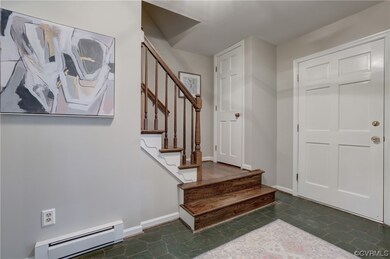 Foyer with stairs and coat closet.