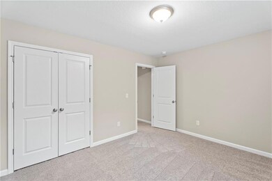 Unfurnished bedroom with carpet flooring, baseboards, and a closet
