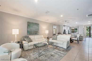 Living room featuring ornamental molding, light ti