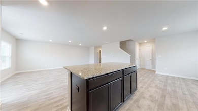 Kitchen featuring light stone counters, a kitchen 