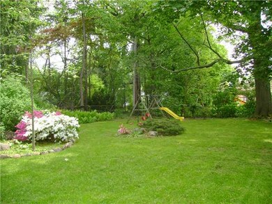 Exterior Back. Beautiful flowers and a sturdy play